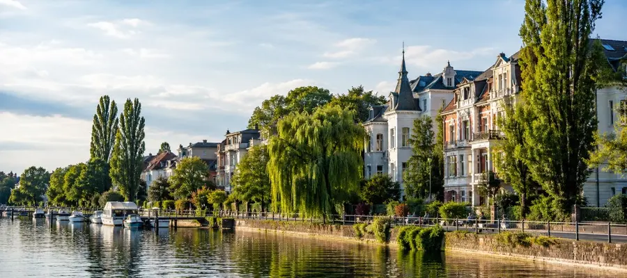 Waterfront promenade in Berlin Köpenick with historic villas and greenery along the river